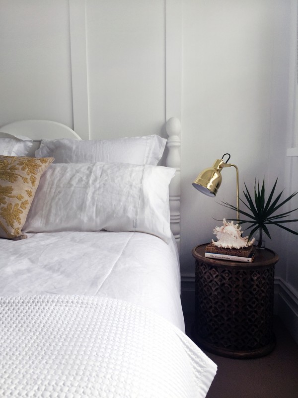 Layers of texture in the master bedroom with bedding by Sheridan. Photo by Rebecca Lowrey Boyd.