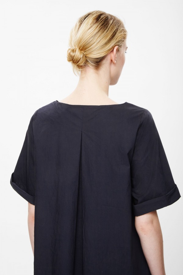 Pleated back dress, available in navy and green, £59, from COS.