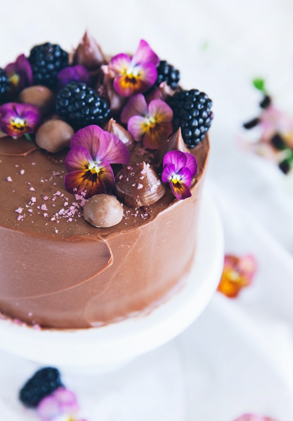 Chocolate and Nutella vertical roll cake with fruit and edible flowers by Call Me Cupcake.
