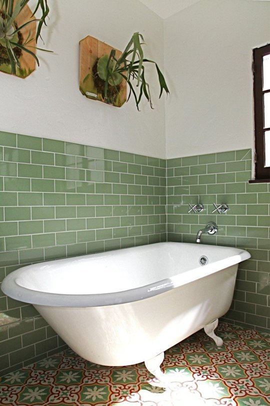 Go green in the bathroom by combining green tiled walls with mounted staghorns, via Granada Tile. 