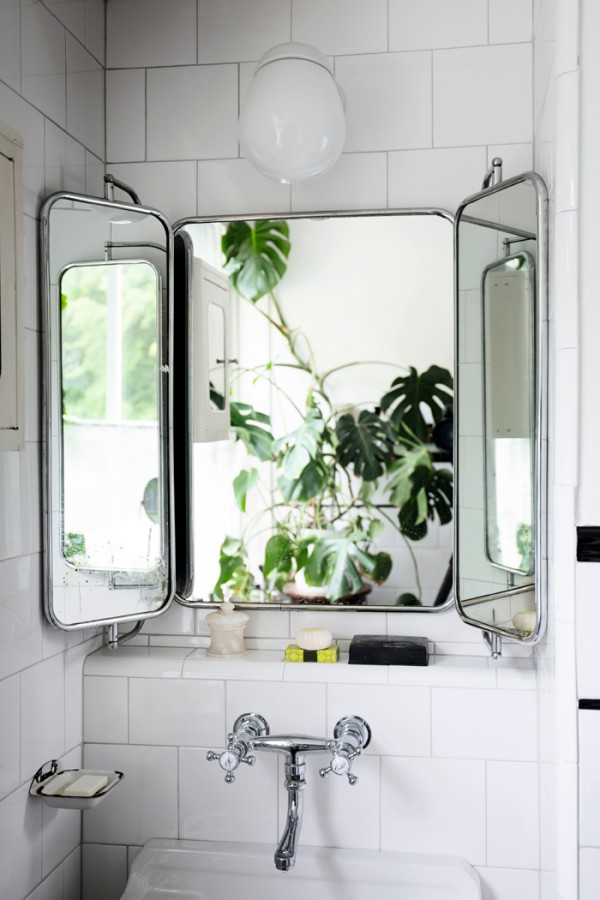 In this bathroom, a monstera has been positioned directly behind the mirror to effectively double the leafy view. Via Elle Decoration Sweden. Photography by Johan Sellén.
