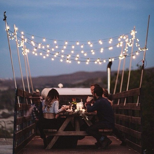String lights add a touch of magic to this dining table - truck style. 