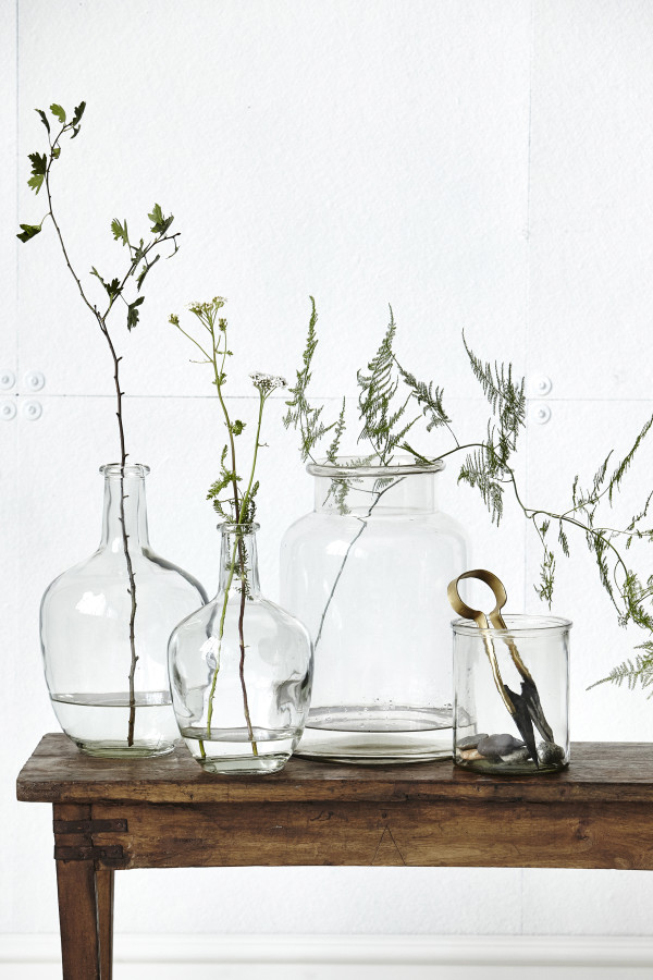 How to style a vignette inspired by by Danish brand House Doctor: glass jars and foliage.