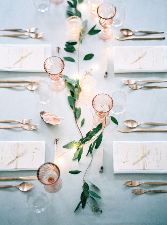 A simple jasmine garland adorns this classic table setting, via Wedding Sparrow.  