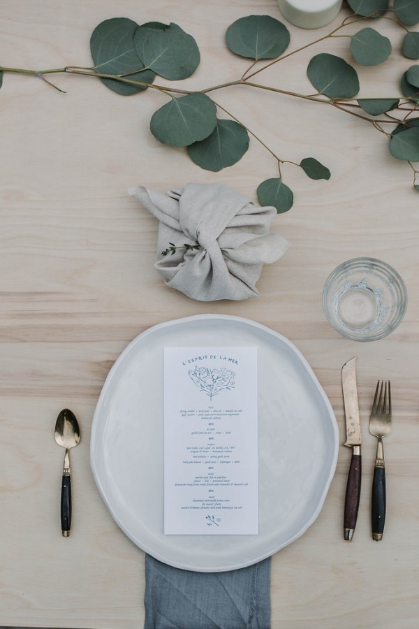 Take inspiration with this table setting from a Kinfolk dinner, featuring handmade & dyed grey linens, ceramics by Handmade Studio around a low table . Seating takes the form of sheepskins. Decorate the table with trails of silver dollar eucalyptus.