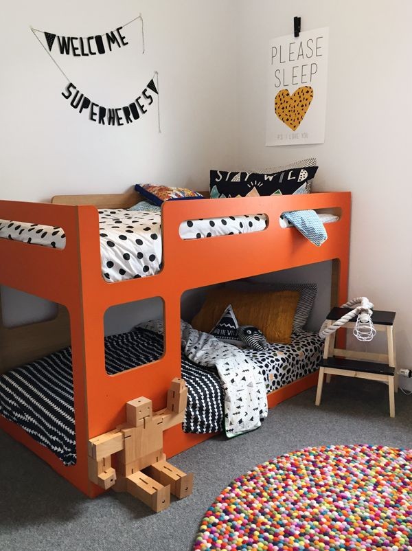 A bright orange bunk bed sets the scene for this gorgeous bedroom for two little boys by We Are Scout.