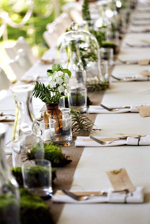 Moss and terrariums bring this table to life. Photo by Erin Grace via 100 Layer Cake