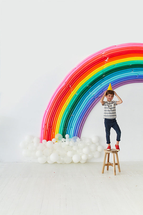 The ultimate rainbow Christmas gift guide for kids. DIY Rainbow Backdrop by Oh Happy Day.